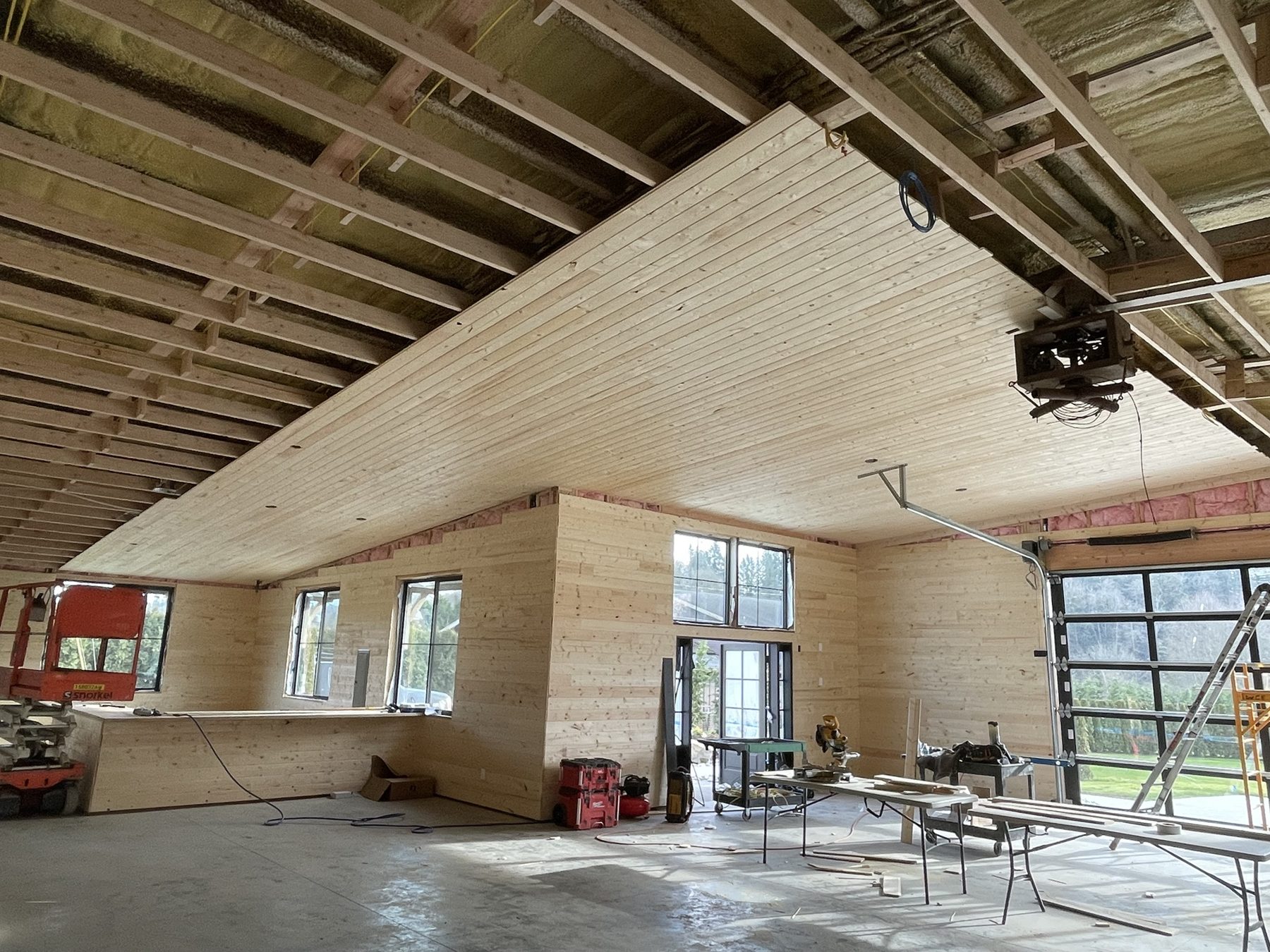 Pine ceiling being installed in a large open building